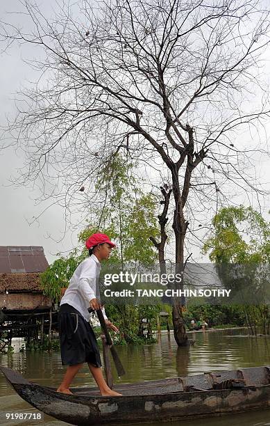 Cambodian girl rows her boat at a flooded village in Kandal province, some 25 kilometres east of Phnom Penh, on October 19, 2009. Cambodian Prime...