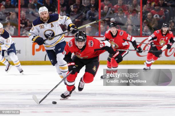 Mike Hoffman of the Ottawa Senators skates with the puck into the offensive zone as Ryan O'Reilly of the Buffalo Sabres and Matt Duchene of the...