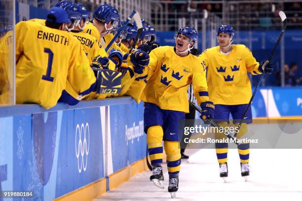 Patrik Zackrisson of Sweden celebrates with teammates after scoring a goal in the third period against Finland during the Men's Ice Hockey...