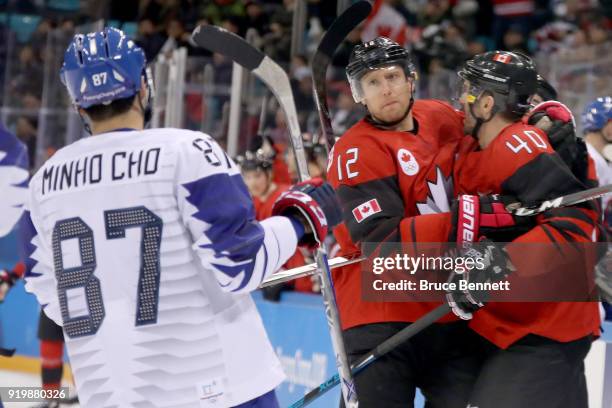 Maxim Lapierre of Canada celebrates with Rob Klinkhammer after scoring a goal on Matt Dalton of Korea in the third period during the Men's Ice Hockey...