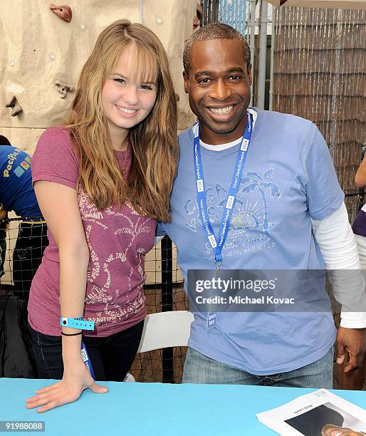 Actress Debby Ryan and actor Phill Lewis sign autographs at the Mattel And Children's Hospital UCLA's "Party On The Pier" at Santa Monica Pier on...