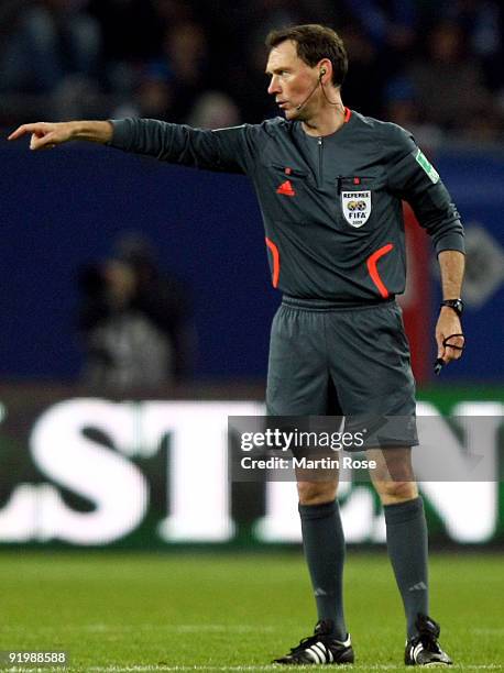 Referee Florian Meyer makes a point during the Bundesliga match between Hamburger SV and Bayer Leverkusen at the HSH Nordbank Arena on October 17,...