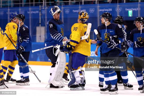 Goalies Mikko Koskinen of Finland and Viktor Fasth of Sweden shake hands after the Men's Ice Hockey Preliminary Round Group C game on day nine of the...