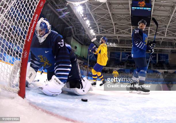 Mikko Koskinen of Finland looks on after allowing a goal in the third period by Patrik Zackrisson of Sweden as Viktor Stalberg of Sweden celebrates...