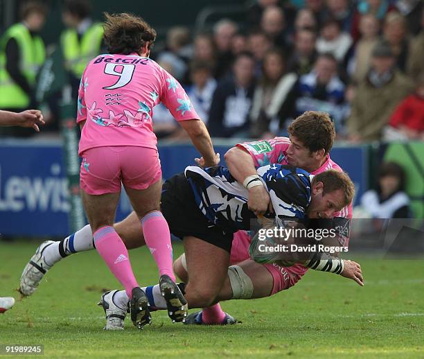 Peter Short of Bath is tackled by Pascal Pape during the Heineken Cup match between Bath and Stade Francais at the Recreation Ground on October 18,...