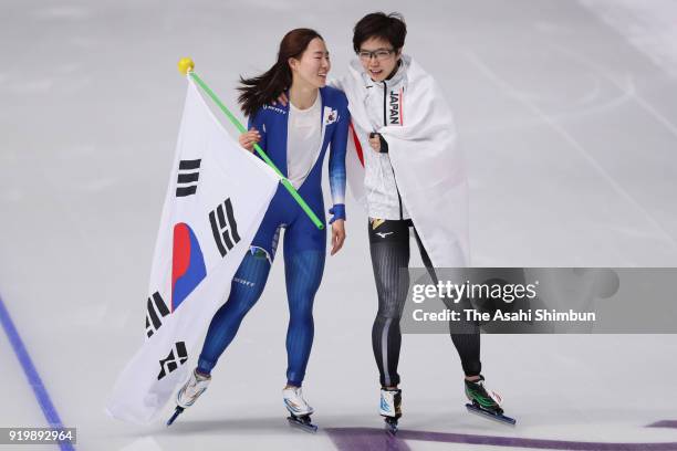Gold medalist Nao Kodaira of Japan and silver medalist Lee Sang-hwa of South Korea embrace after the Ladies' 500m Individual Speed Skating Final on...