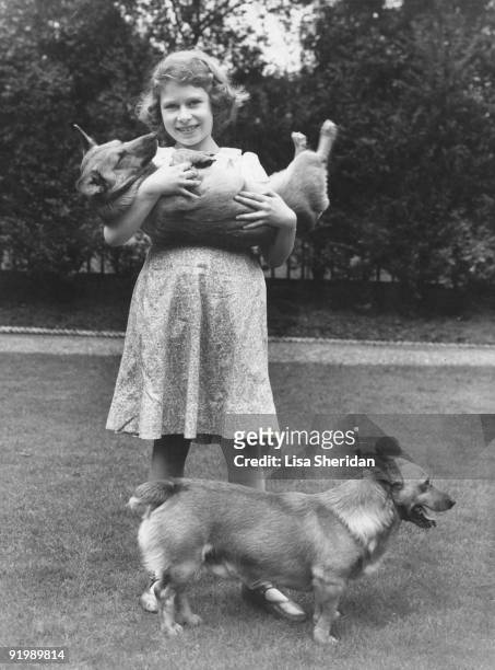 Princess Elizabeth with two corgi dogs at her home at 145 Piccadilly, London, July 1936.