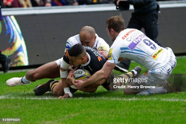 Marcus Watson of Wasps scores their first try despite the efforts of Olly Woodburn and Will Chudley of Exeter Chiefs during the Aviva Premiership...