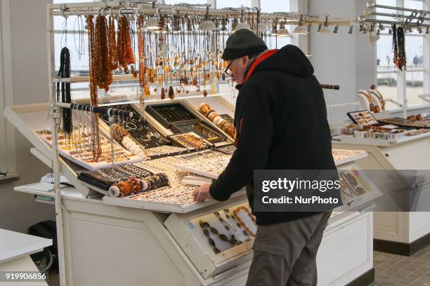 People buying amber souvenirs are seen in winter scenery in Baltic Sea coastal resort of Sopot, northern Poland on 18 February 2018