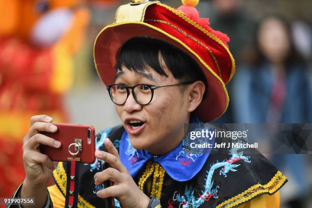 Person takes photos as the Chinese community in Glasgow celebrate during Lunar New Year celebrations for the Year of the Dog at George Square on...