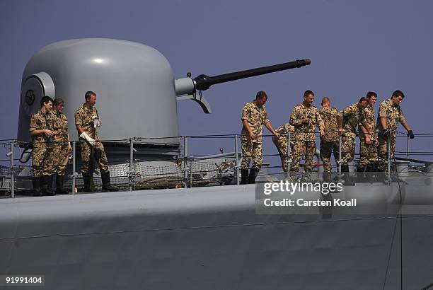 Crew members standing on the deck of the frigate Karlsruhe in the Port of Djibouti on December 15, 2008 in Djibouti. The warship F212 of the German...
