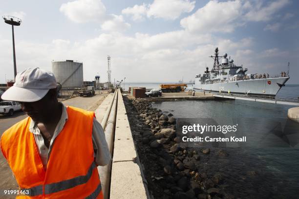 Dock worker sits on the pier where the german frigate Karlsruhe is docked in the Port of Djibouti on December 15, 2008 in Djibouti. The warship F212...