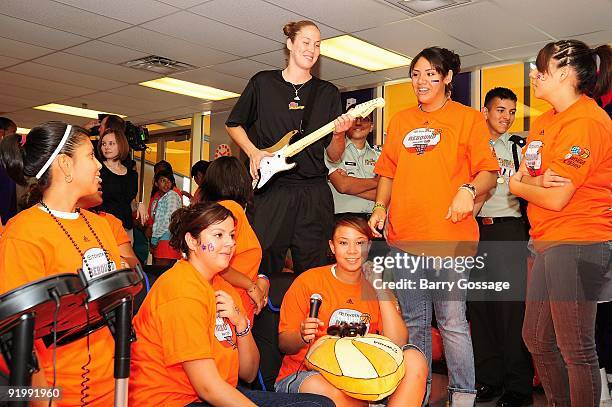 Nicole Ohlde of the Phoenix Mercury plays Rock Band with young participants during the WNBA, Toyota and Phoenix Mercury unveiling of the Reading and...