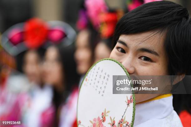 Woman looks on as the Chinese community in Glasgow celebrate during Lunar New Year celebrations for the Year of the Dog at George Square on February...