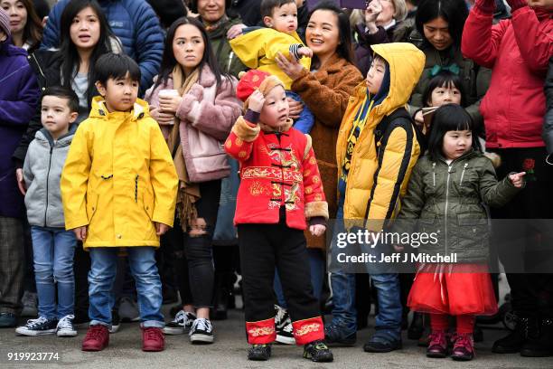 Children watch as the Chinese community in Glasgow celebrate during Lunar New Year celebrations for the Year of the Dog at George Square on February...