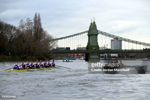 Both crews pass under Hammersmith Bridge during the Boat Race Trial race between Cambridge University Boat Club and University of London on February...