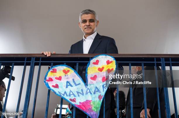 Mayor of London, Sadiq Khan, poses for a photo next to a paper heart that was amongst many created after the Grenfell tower tragedy, during a visit...