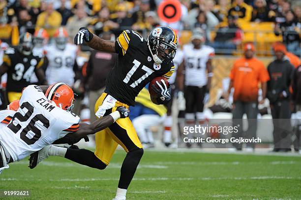 Wide receiver Mike Wallace of the Pittsburgh Steelers runs with the football after catching a pass against safety Abram Elam of the Cleveland Browns...