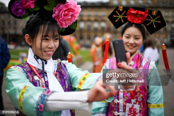 Women take selfie photos as the Chinese community in Glasgow celebrate during Lunar New Year celebrations for the Year of the Dog at Glasgow City...