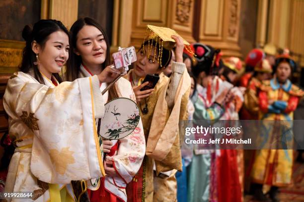 Women take selfie photos as the Chinese community in Glasgow celebrate during Lunar New Year celebrations for the Year of the Dog at Glasgow City...