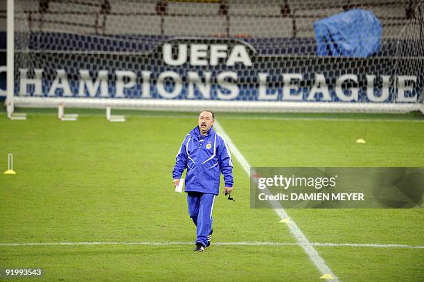 Dynamo Kiev coach Valeri Gazzaev walks on the pitch as he attends a training session at San Siro stadium in Milan on October 19, 2009 on the eve of...