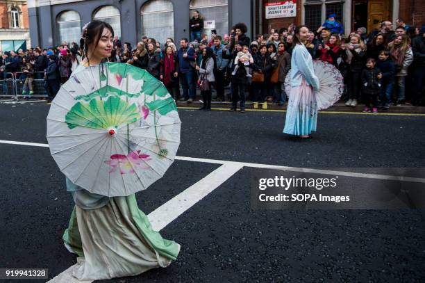 Women dressed with traditional Chinese costume seen on the Chinatown streets during the Chinese New Year celebration. Chinese London community...