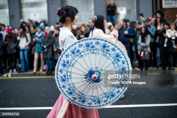 Woman dressed with traditional Chinese costume seen on the Chinatown streets during the Chinese New Year celebration. Chinese London community...