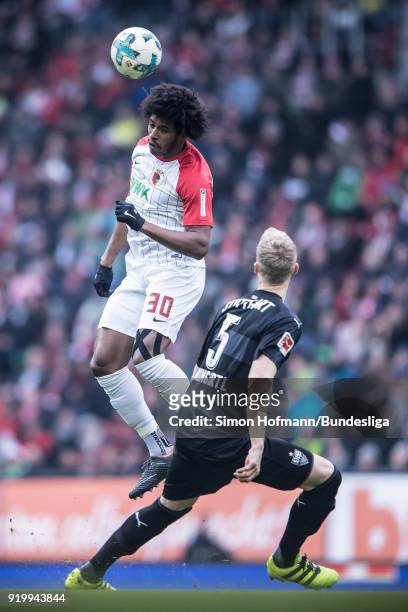 Francisco da Silva Caiuby of Augsburg jumps for a header with Timo Baumgartl of Stuttgart during the Bundesliga match between FC Augsburg and VfB...