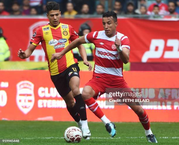 Tunisia's Club Africain player Khalil dribbles the ball as Esperance Sportive de Tunis' player Montassar Talbi defends during the Tunisia Ligue 1...