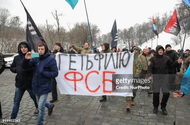 Protesters carry the placard reading &quot;Get FSB branch out!&quot; along their way. Several dozens of supporters and members of the right-wing...