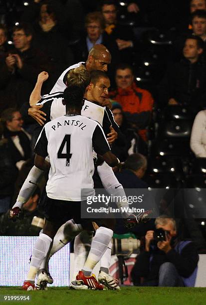 Bobby Zamora of Fulham celebrates scoring a goal with team mates during the Barclays Premier League match between Fulham and Hull City at Craven...