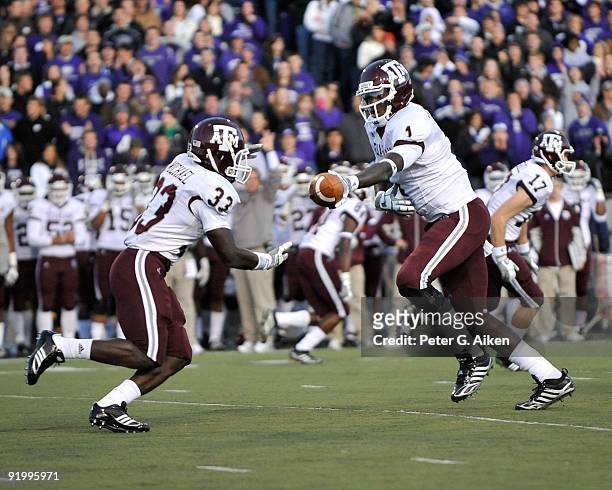 Quarterback Jerrod Johnson of the Texas A&M Aggies hands the ball off to running back Christine Michael against the Kansas State Wildcats in the...