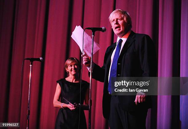 Mayor of London Boris Johnson talks on stage watched by film festival artistic director Sandra Hebron after arrivals for the premiere of 'Bright...