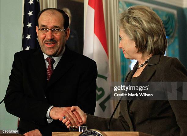 Secretary of State Hillary Clinton and Prime Minister of Iraq Nouri al-Maliki talk to reporters after a meeting at the State Department on October...