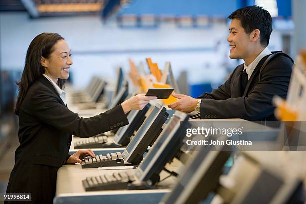 businessman checks in at airport. - airport check in counter stock pictures, royalty-free photos & images