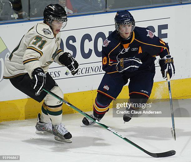 Alex Hutchings of the Barrie Colts and Phil Varone of the London Knights both chase after the puck in a game on October 16, 2009 at the John Labatt...