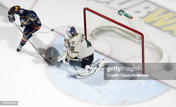 Colin Behenna of the Barrie Colts tips a shot on Michael Hutchinson of the London Knights in a game on October 16, 2009 at the John Labatt Centre in...