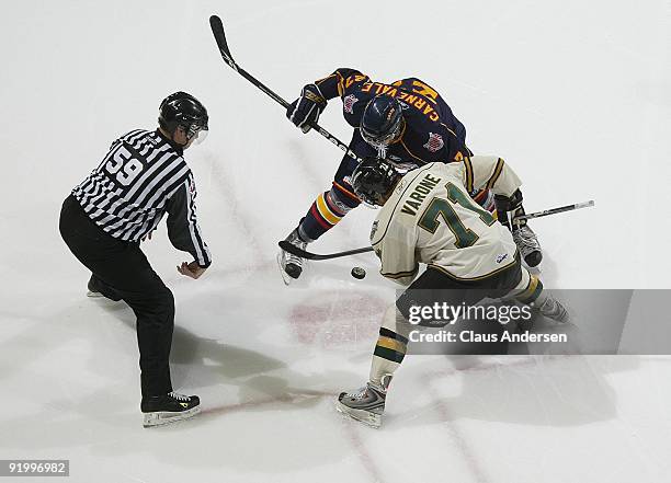 Taylor Carnevale of the Barrie Colts takes a faceoff against Phil Varone of the London Knights in a game on October 16, 2009 at the John Labatt...