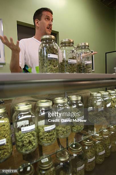 Dave Warden, a bud tender at Private Organic Therapy , a non-profit co-operative medical marijuana dispensary, displays various types of marijuana...