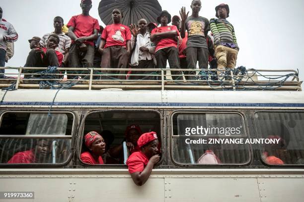 Supporters of the late Movement for Democratic Change leader Morgan Tsvangirai stand on the roof of a bus as they attend an address by acting MDC...