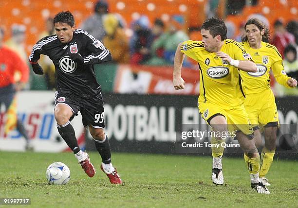 Jaime Moreno of D.C. United pushes away from Danny O'Rourke of the Columbus Crewduring an MLS match at RFK Stadium on October 17, 2009 in Washington,...