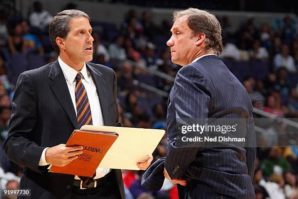 Head coach Flip Saunders and assistant coach Randy Wittman of the Washington Wizards stand on the sideline during the preseason game against the...