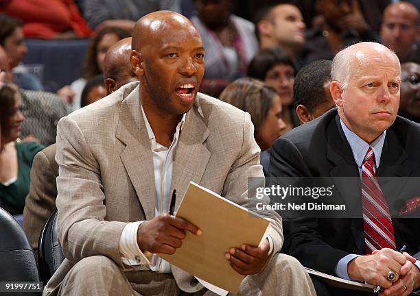 Assistant coaches Sam Cassell and Don Zierden of the Washington Wizards observe from the sideline during the preseason game against the Dallas...