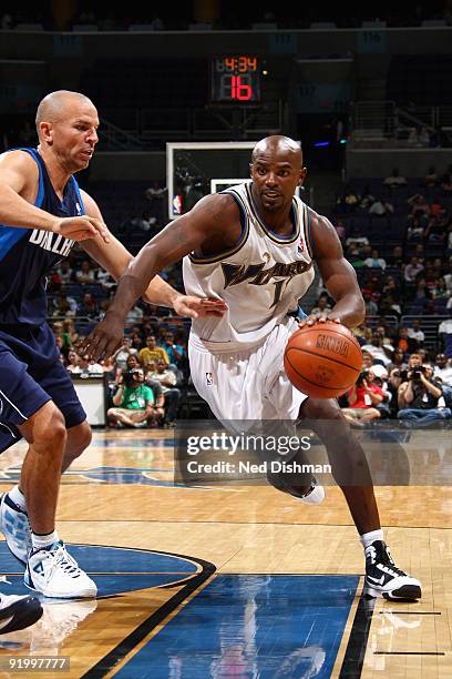 Mike James of the Washington Wizards drives to the basket against Jason Kidd of the Dallas Mavericks during the preseason game on October 9, 2009 at...