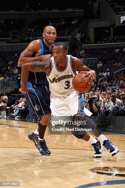 Caron Butler of the Washington Wizards drives past Shawn Marion of the Dallas Mavericks during the preseason game on October 9, 2009 at the Verizon...