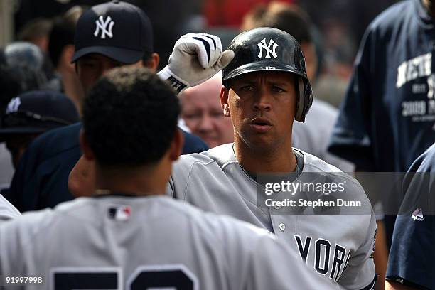 Alex Rodriguez of the New York Yankees celebrates with teammates after hitting a home run during the forth inning off Jered Weaver of the Los Angeles...