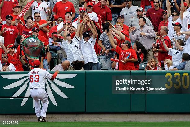 Bobby Abreu of the Los Angeles Angels of Anaheim looks on as fans catch Johnny Damon of the New York Yankees home run off Jered Weaver during the...