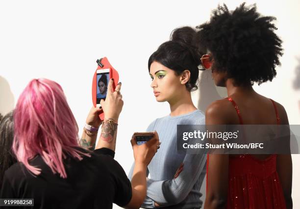 Models backstage ahead of the Ashish show during London Fashion Week February 2018 at BFC Show Space on February 18, 2018 in London, England.