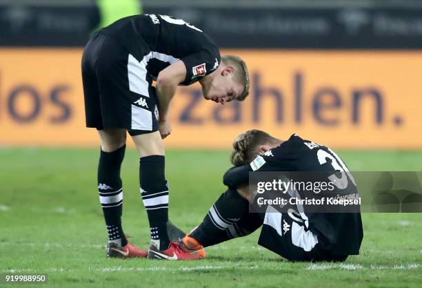 Patrick Herrmann comforts Nico Elvedi of Moenchengladbach after the Bundesliga match between Borussia Moenchengladbach and Borussia Dortmund at...
