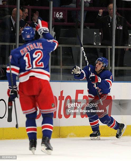 Michael Del Zotto of the New York Rangers scores a power play goal against the San Jose Sharks and is joined by Ales Kotalik at Madison Square Garden...